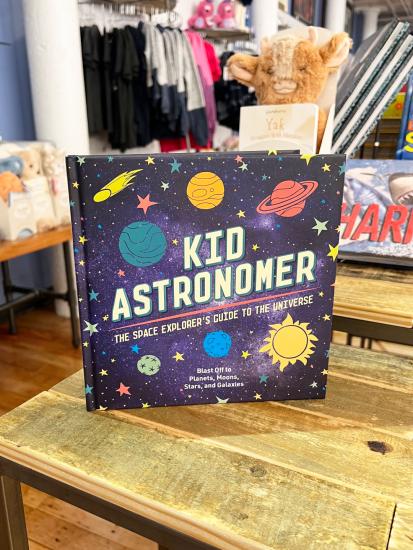 Book on Display Featuring Cover with A starry sky and Planets Titled Kid Astronomer The Space Explorer's Guide to the Universe