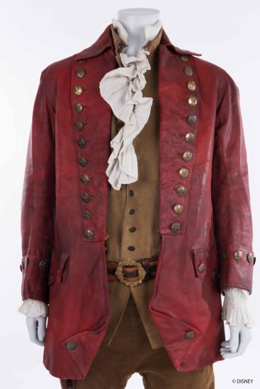 Mannequin on white background wearing red knee length coat, a tan vest and frilly white shirt
