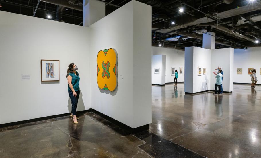 Individuals viewing art work in a gallery